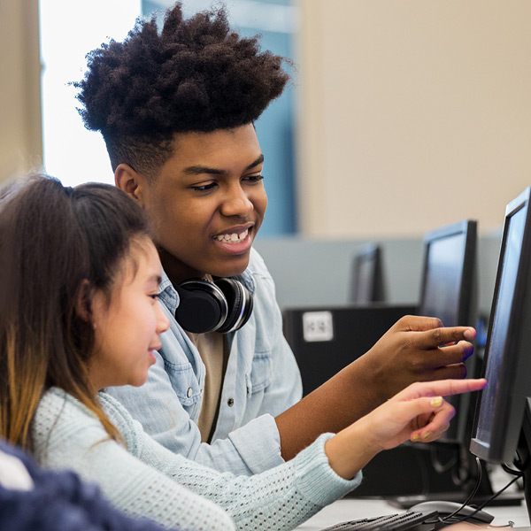 Students looking at computer