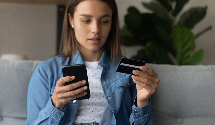 Lady using her bank card for online purchases 